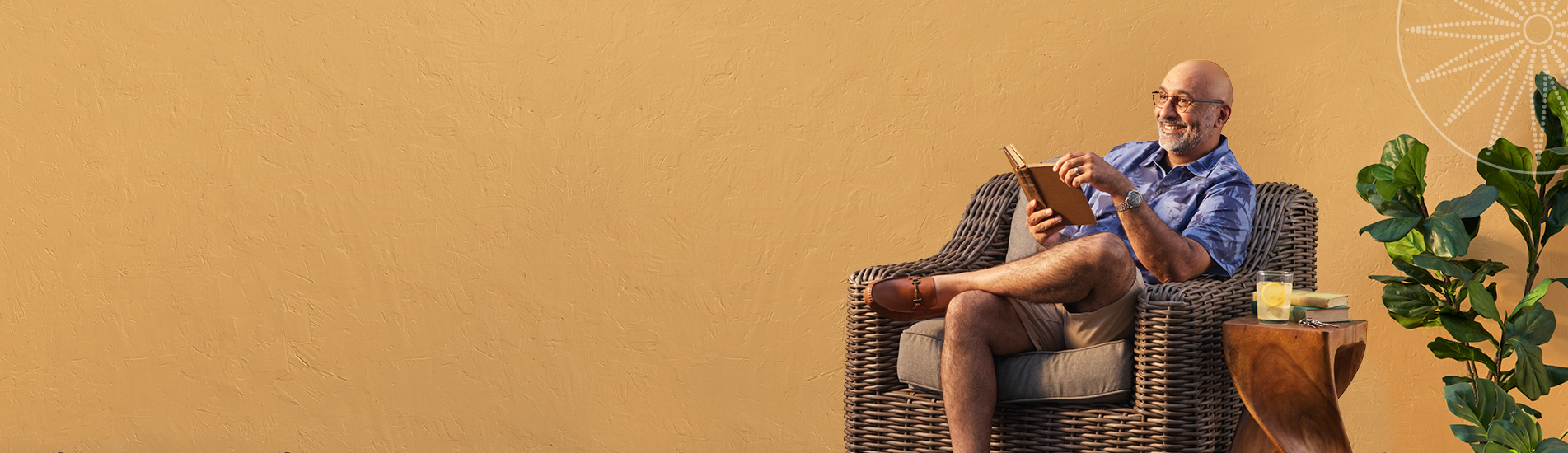 older man reading a book while at his resort home